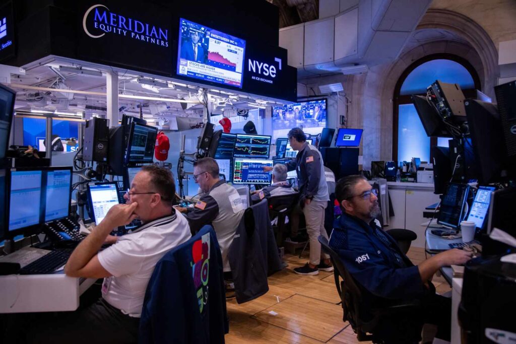 Traders work on the floor at the New York Stock Exchange