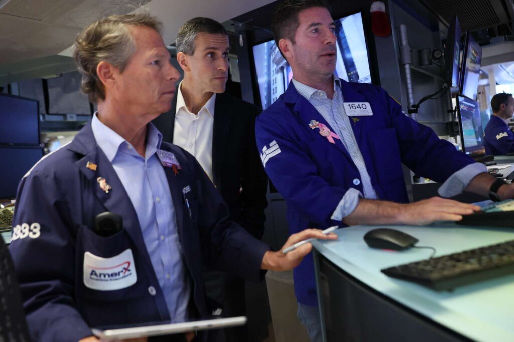 Traders work on the floor of the New York Stock Exchange