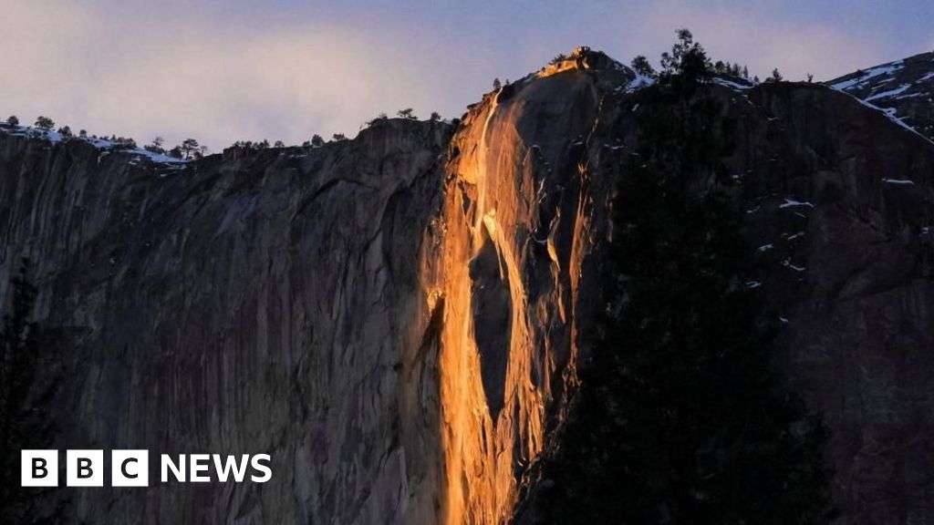 [Yosemite waterfall displays vibrant orange hue.
