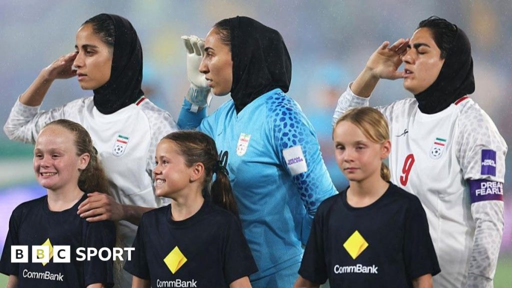 Iranian soccer players participate in anthem ceremony at Asian Cup following previous silence.