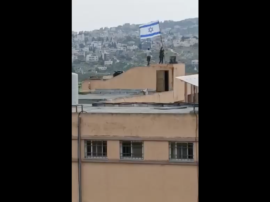 Israeli settlers deface educational institution and hoist national flag in contested West Bank area