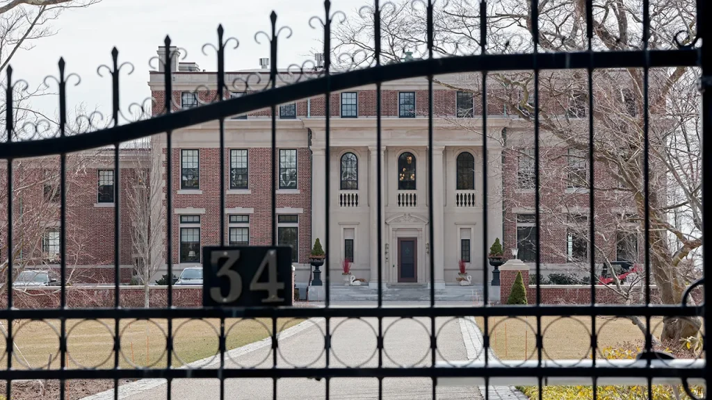 Police search for armed individual following robbery at Massachusetts estate, where housekeeper was restrained.