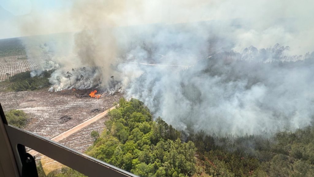 A rapidly spreading wildfire in Georgia covers over 31 square miles, prompting potential evacuations.