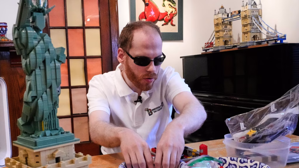 Blind individual pioneers methods to assist those with low vision in constructing Lego sets.
