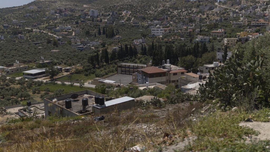 Israeli settlers compel Palestinian family to disinter and reinter deceased relative.