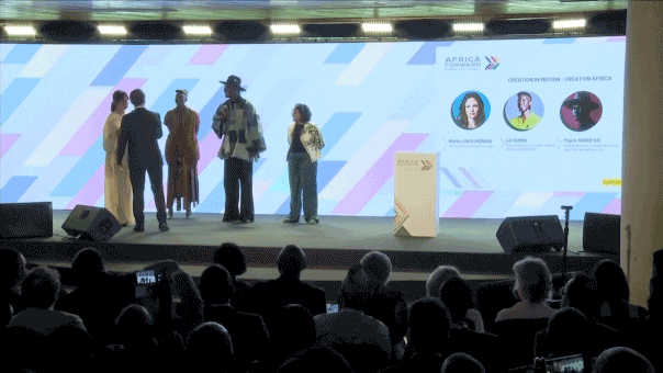 [Macron reprimands attendees at Africa Forward Summit for interrupting speakers.